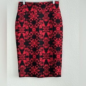 Red and black knee length skirt with a slit at the back.